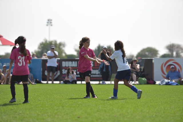 Girl running on soccer field