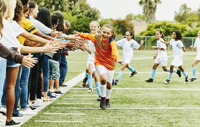 Young female soccer player running 