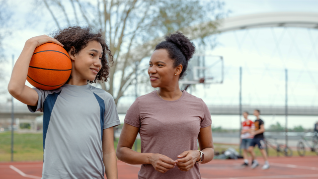 Two kids playing basketball talking