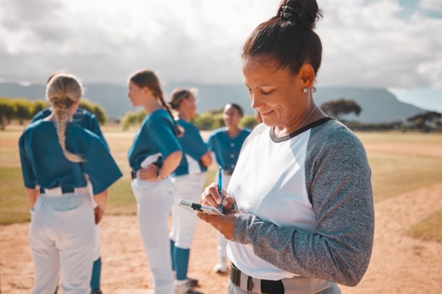 Baseball notes, sports game and woman in collaboration with team on field