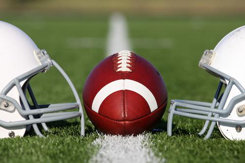 Football Between Two Helmets