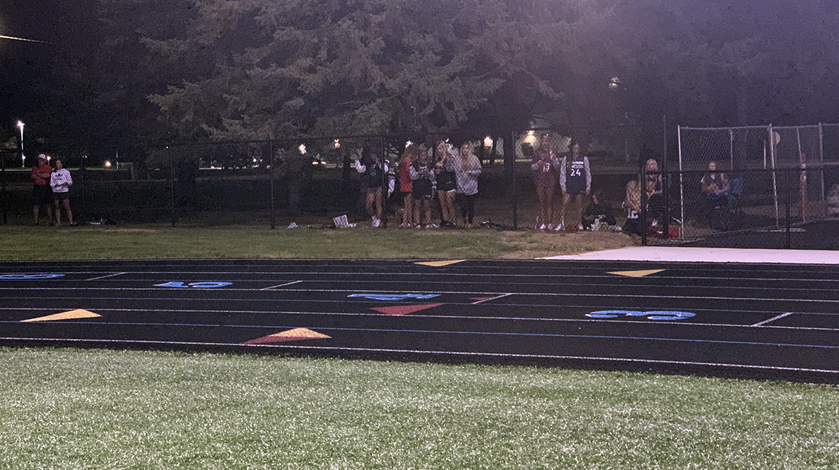 Muskego fans watch from behind the fence