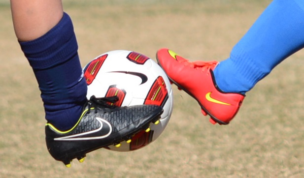 Soccer Ball Kicked By Two Cleats