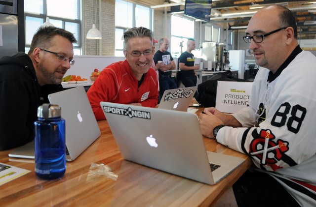 Three Men Around Laptops at SportsEngine