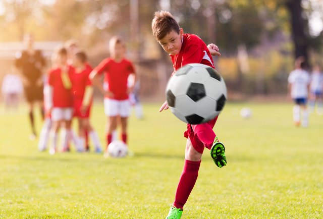 Soccer player kicking ball