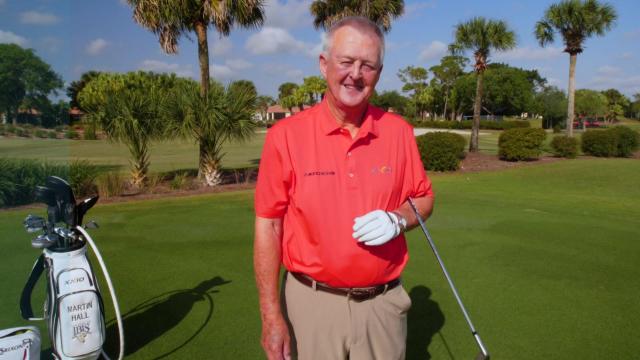 Martin Hall on a golf course looking into camera
