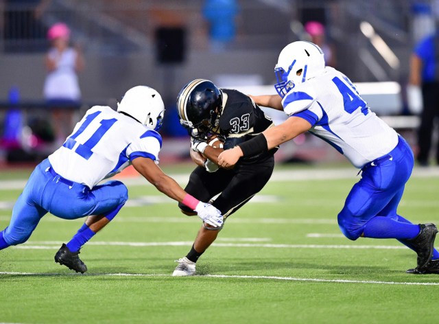 Football player making a tackle during a game