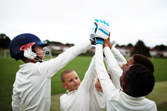 Group of young athletes doing a high five