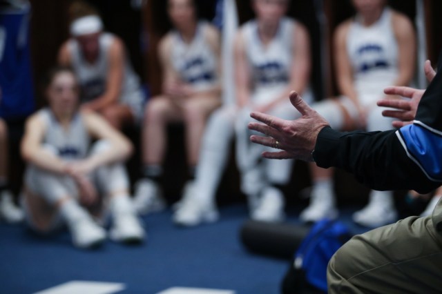 A coach talks to his players during halftime