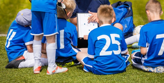 Coach Coaching Kids Soccer Team