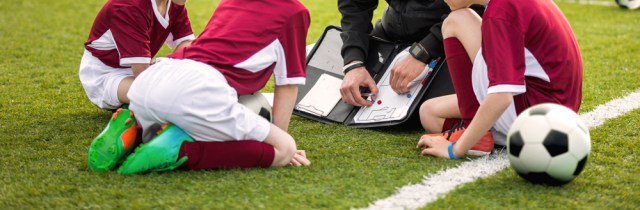 Coach coaching soccer kids soccer team