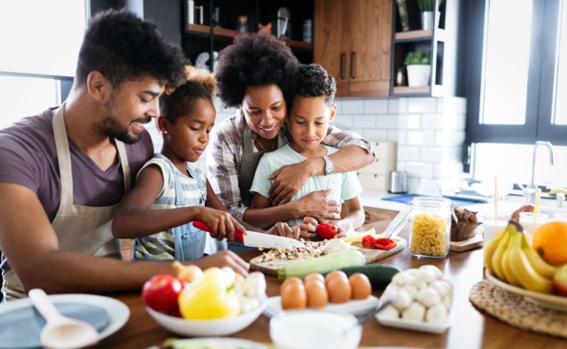 Happy family in the kitchen having fun and cooking together