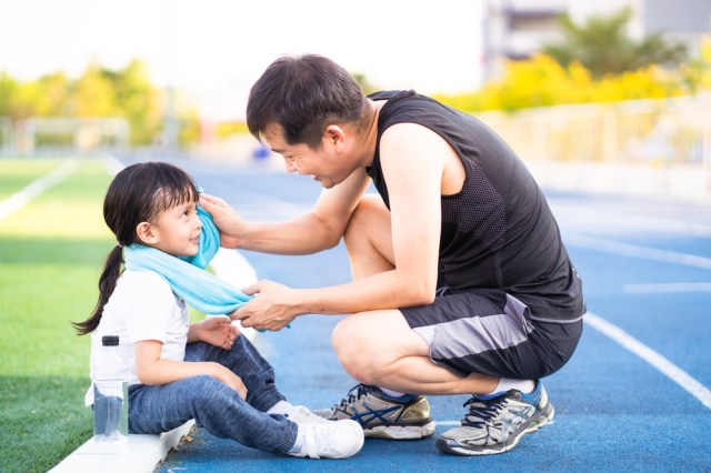 father is wiping sweat for the little daughter
