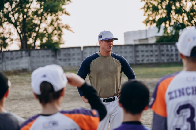 Kyiv, Ukraine - June 3, 2020: A serious coach communicates with his students outdoors