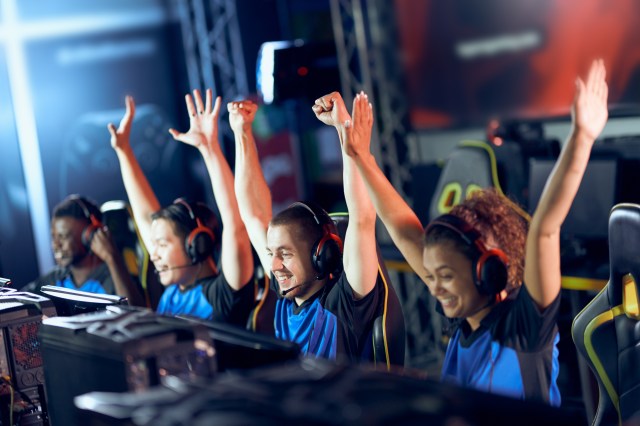 Team of happy professional cyber sport gamers