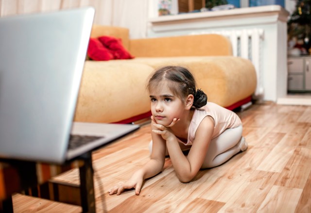 Online hobby, fitness, distant training. Young ballerina practicing classic choreography during online ballet class at home before laptop, social distance during quarantine, online education