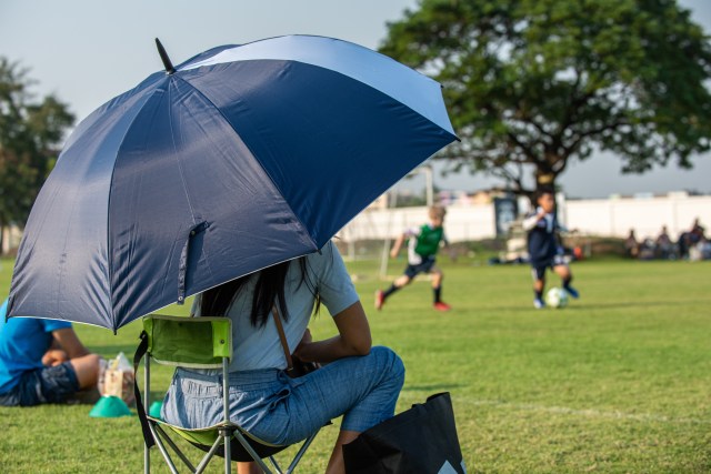 Parent watching youth sports game from the sidelines