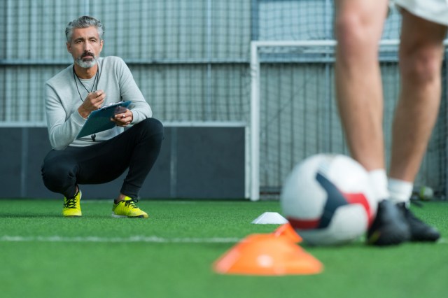 football coach training football player