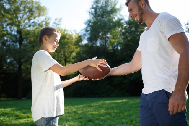 Father son playing football