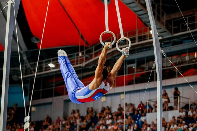 still rings exercise athlete gymnast to competition in gymnastics