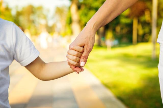 Cropped close up of a boy holding hands