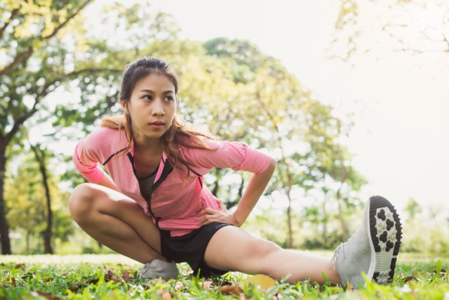 Healthy young asian woman exercising at park.