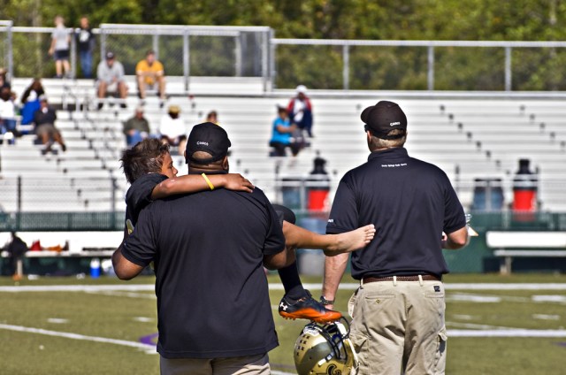 CUMMING, GA - OCTOBER 8 : Unidentified injured player being carried off the field by coaches during a football game