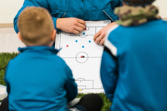 Youth Soccer Coach Coaching Children.