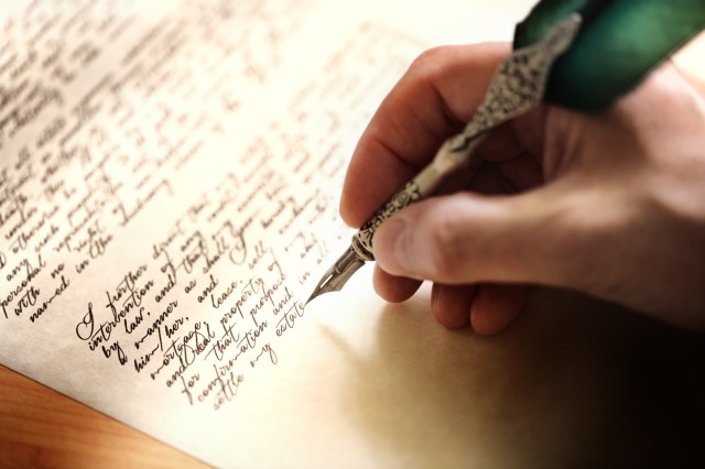 Writing with quill pen last will and testament or concept for law, legal issues or author